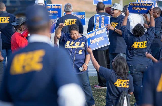 Members holding Respect Federal Employees signs